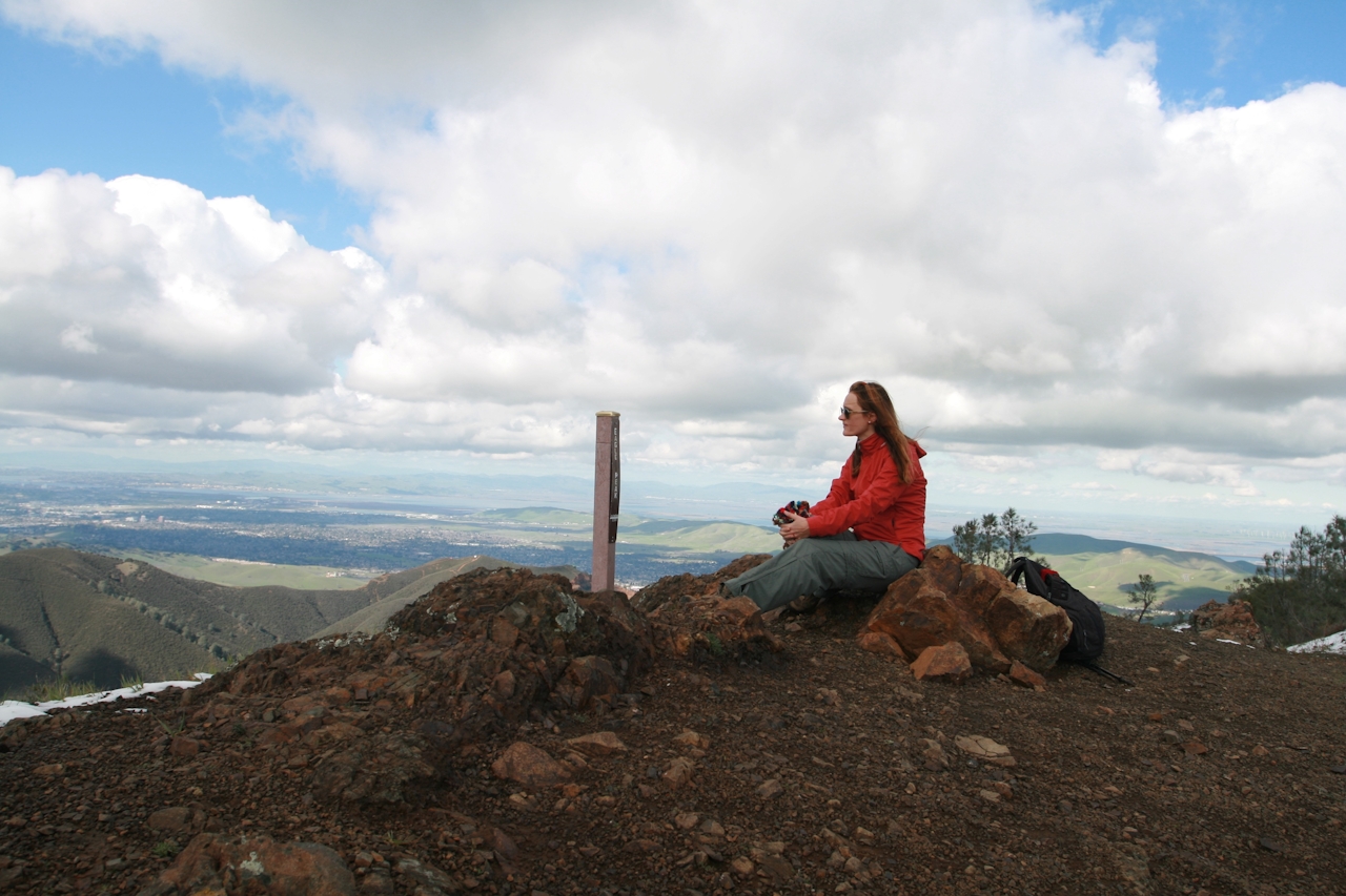 A woman sits the summit of Eagle Peak in Mount Diablo State Park 
